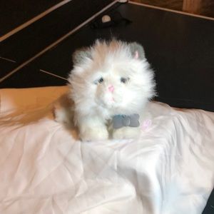 It moves and makes noises, if petted it purrs.